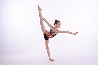 Young Gymnast Performing Standing Split in Studio