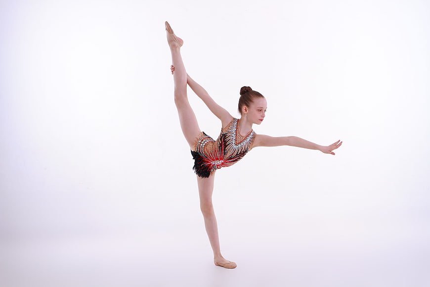 Young Gymnast Performing Standing Split in Studio