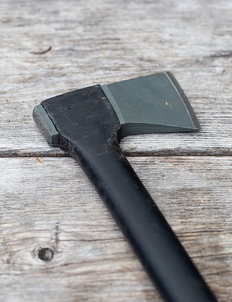 Rusty Hatchet on Weathered Wooden Planks