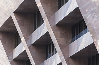 Modern geometric building facade with diagonal metal beams