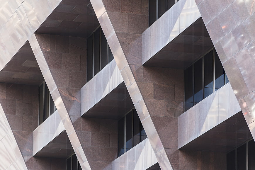 Modern geometric building facade with diagonal metal beams