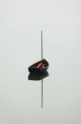 Minimalist Wooden Boat on Calm Misty Water