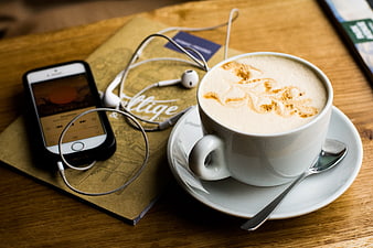 Latte with Smartphone and Earphones on Wooden Table