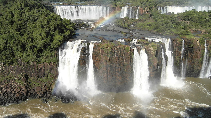 Iguazu Falls Waterfall Nature Landscape With Rainbow And Tropical Forest