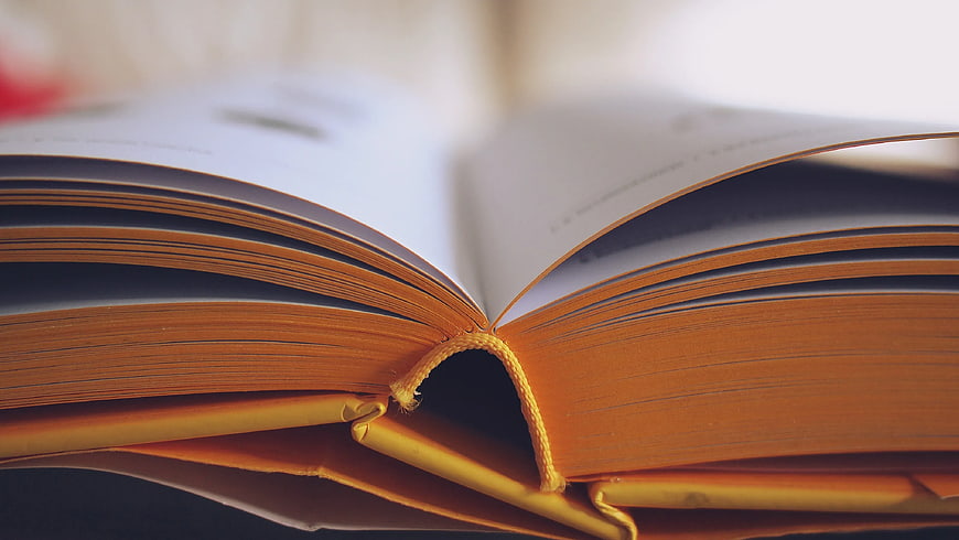 Close-up of Open Book with Yellow Bookmark