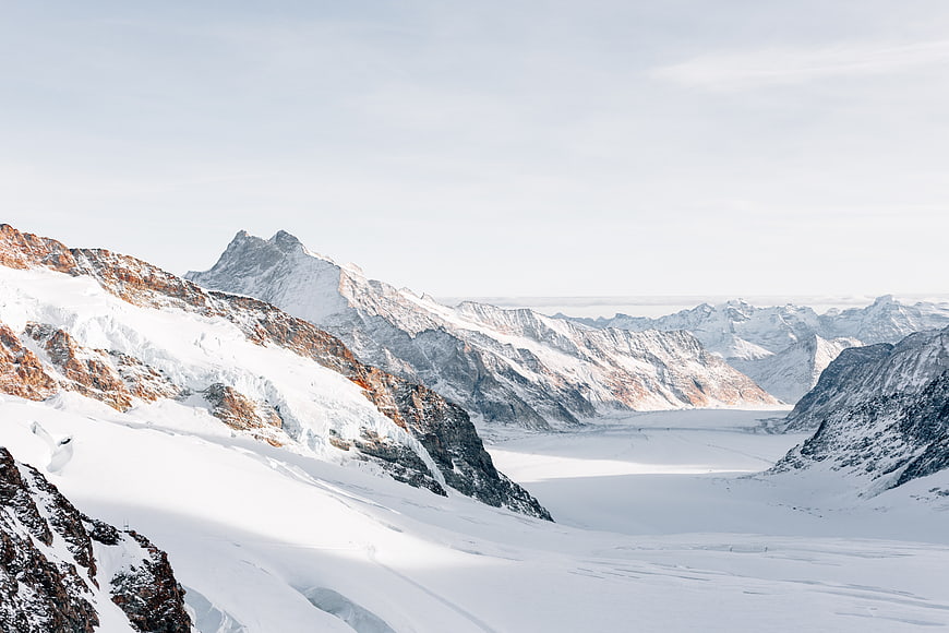 Majestic Snow-Covered Mountain Range with Glacial Valley