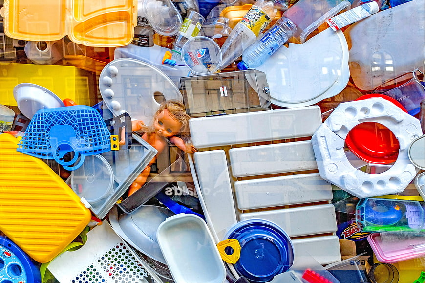 Colorful plastic waste pile in recycling bin