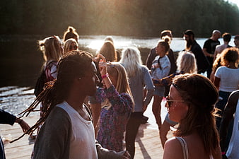 Diverse crowd dancing at summer lakeside party