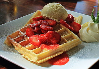 Delicious Waffle with Strawberries, Ice Cream, and Whipped Cream