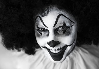 Creepy black and white clown face with stitched smile