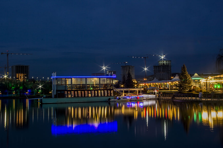Night View of Illuminated Waterfront Restaurant and City Skyline