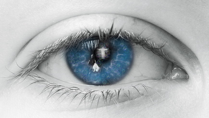 Close-up of blue eye with cross reflection in pupil
