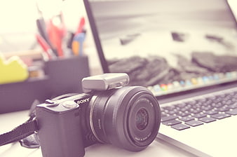 Sony Camera and Laptop on Desk for Photography Workflow