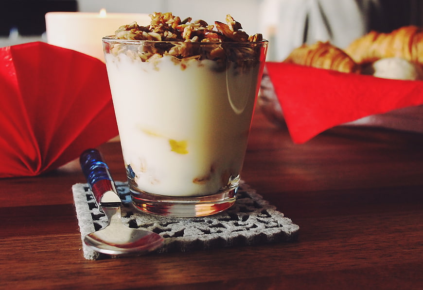 Yogurt Parfait with Granola and Walnuts on Wooden Table