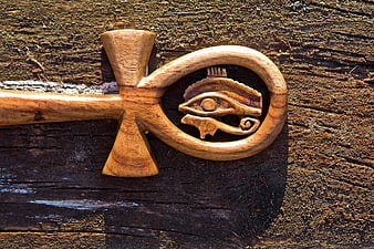 Wooden Ankh with Eye of Horus on Rustic Background