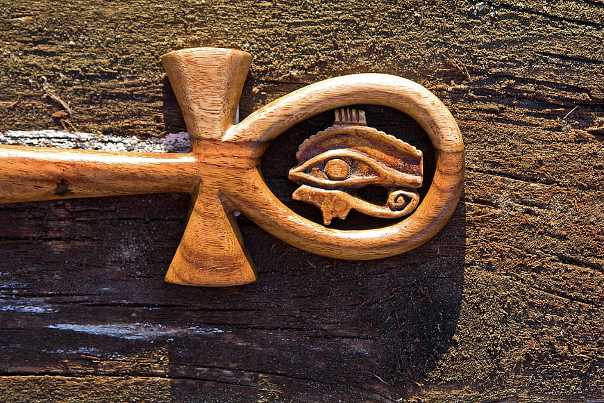 Wooden Ankh with Eye of Horus on Rustic Background