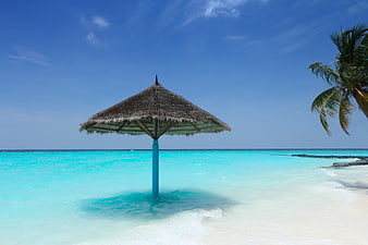 Thatched Beach Umbrella in Turquoise Maldives Water