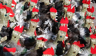 Traditional woven rooster crafts with red combs and feathers