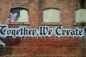Together We Create Graffiti on Weathered Brick Wall