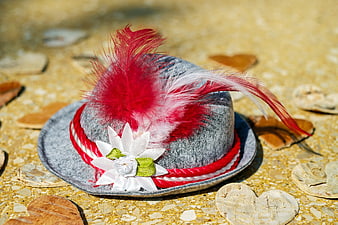 Traditional Bavarian Hat with Red Feathers on Stone Surface