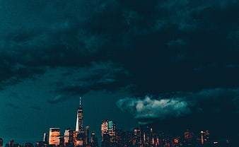 Dramatic New York City Skyline at Night with Dark Clouds