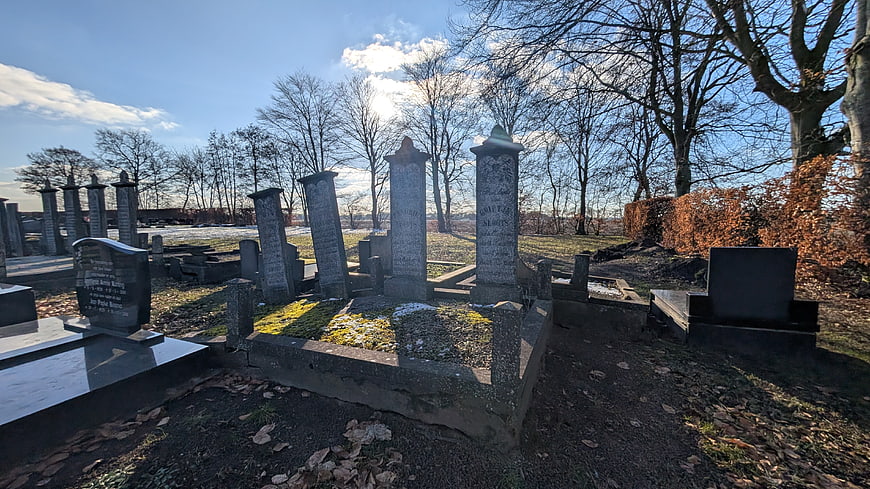 Old Cemetery with Weathered Tombstones in Winter Sunlight