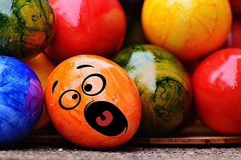 Surprised Easter Egg with Funny Face Among Colorful Eggs