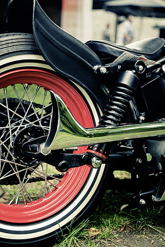Close-up of vintage motorcycle rear wheel and exhaust