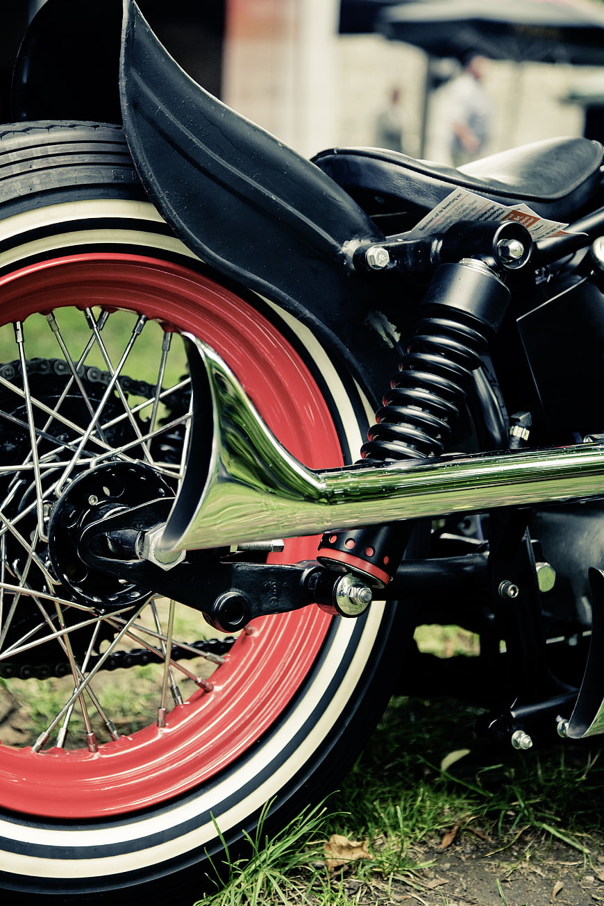 Close-up of vintage motorcycle rear wheel and exhaust