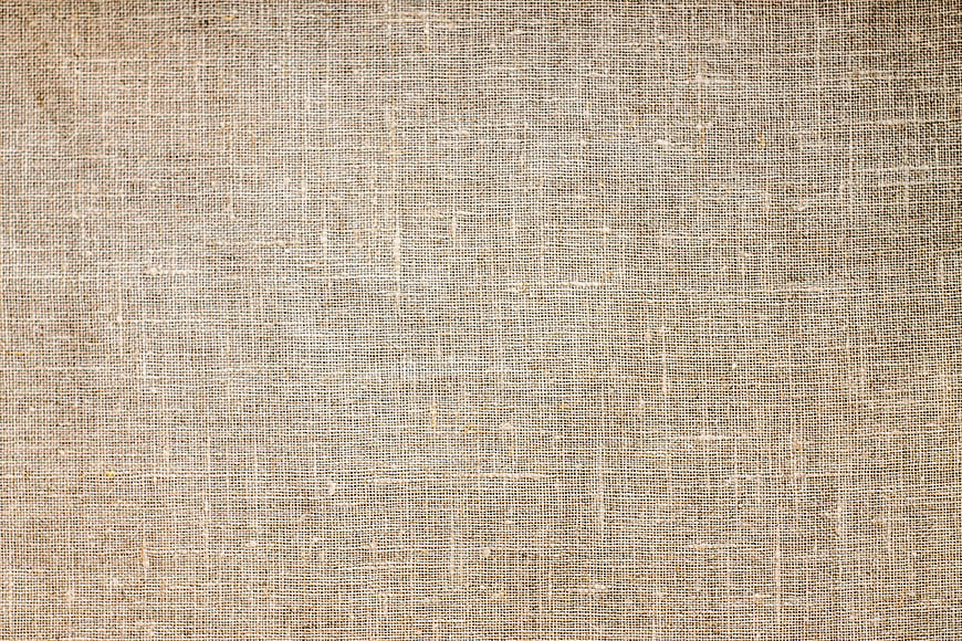 Close-up texture of beige woven burlap fabric background