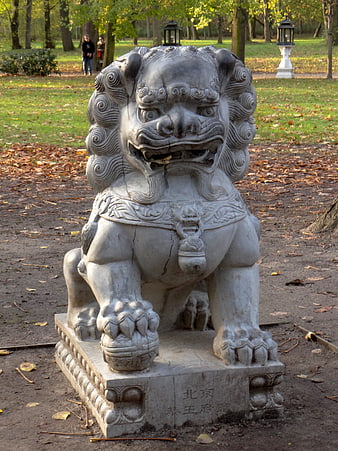 Stone Chinese Guardian Lion Statue in Autumn Park