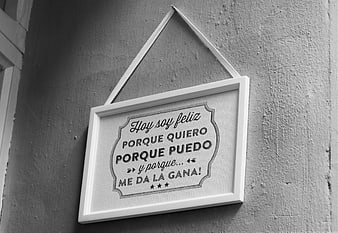 Motivational Spanish Quote in White Frame on Textured Wall