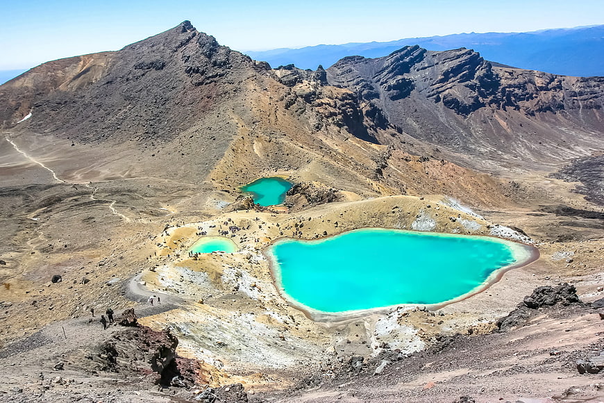 Turquoise volcanic crater lakes in arid mountain landscape
