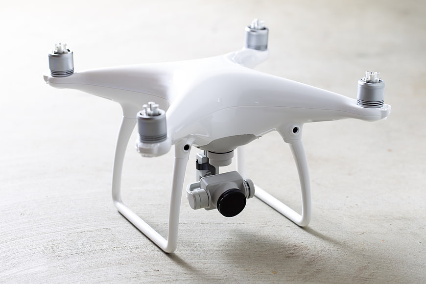 White Quadcopter Drone with Camera on Light Surface