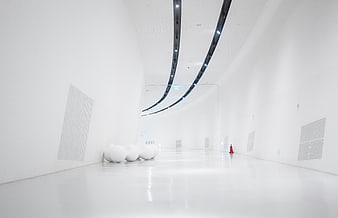 Minimalist white interior with curved ceiling and modern lighting