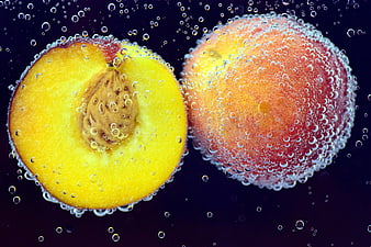 Fresh Peaches Submerged in Sparkling Water with Bubbles