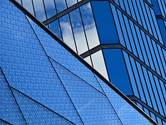 Modern Blue Glass Building Facade with Geometric Patterns
