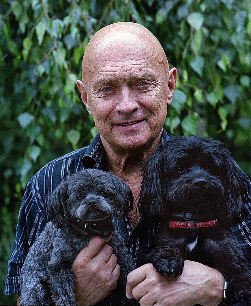 Senior Man Holding Two Small Dogs Outdoors