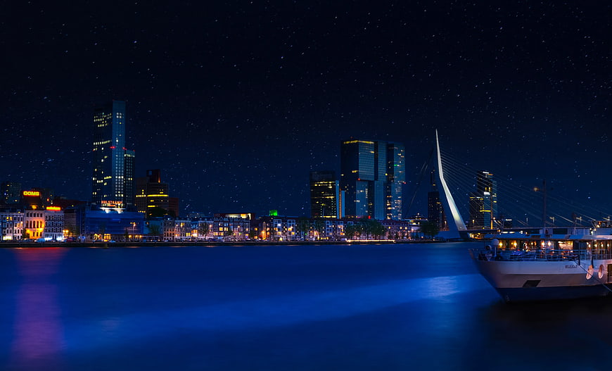 Rotterdam Skyline at Night with Erasmus Bridge and Starry Sky