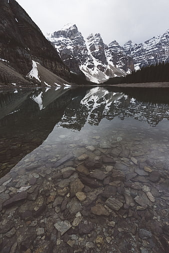 Serene Mountain Lake Reflection with Rocky Shore