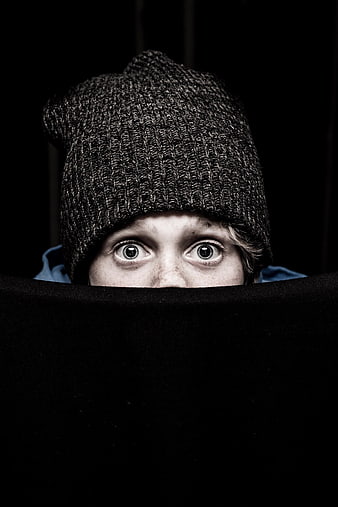 Playful Portrait of Woman Peeking Over Black Barrier
