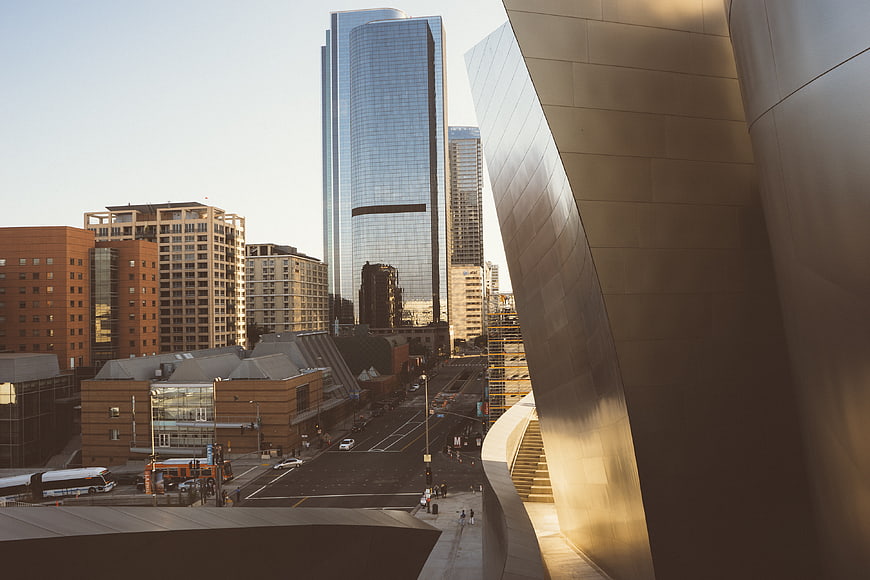 Modern City Architecture with Curved Metal Building and Skyscrapers