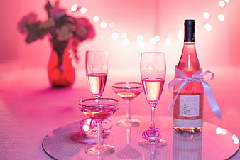 Pink Rosé Wine Bottle and Glasses on Pink Table