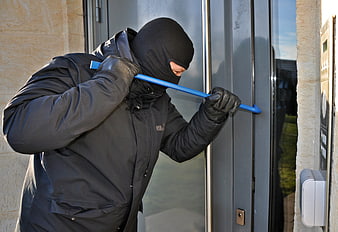 Masked Burglar Using Blue Crowbar to Force Entry Through Glass Door
