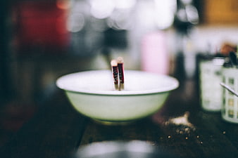Blurred white bowl with chopsticks on wooden table