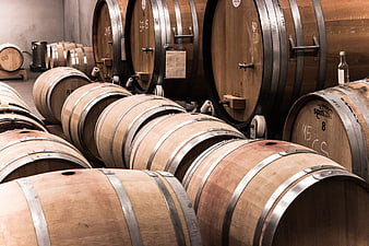 Wooden wine barrels in a rustic cellar