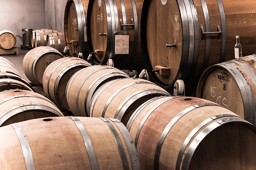Wooden wine barrels in a rustic cellar