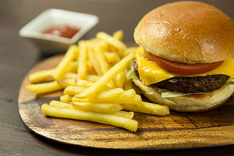Cheeseburger with French Fries and Ketchup on Wooden Board