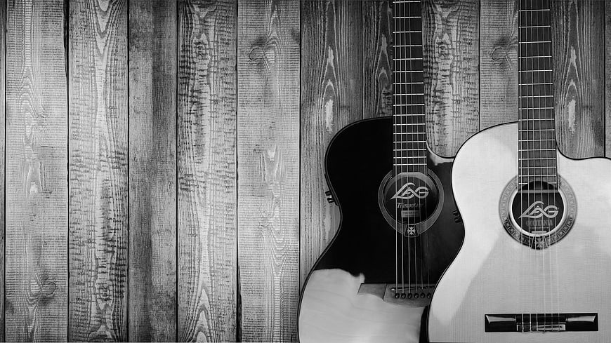 Two Acoustic Guitars on Wooden Background