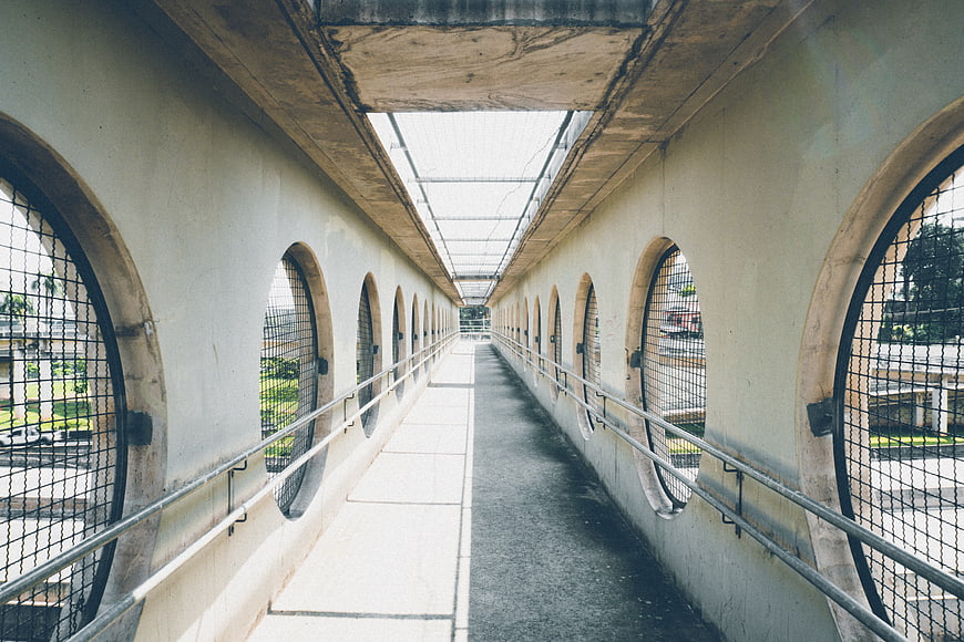 Perspective view of concrete walkway with arched windows